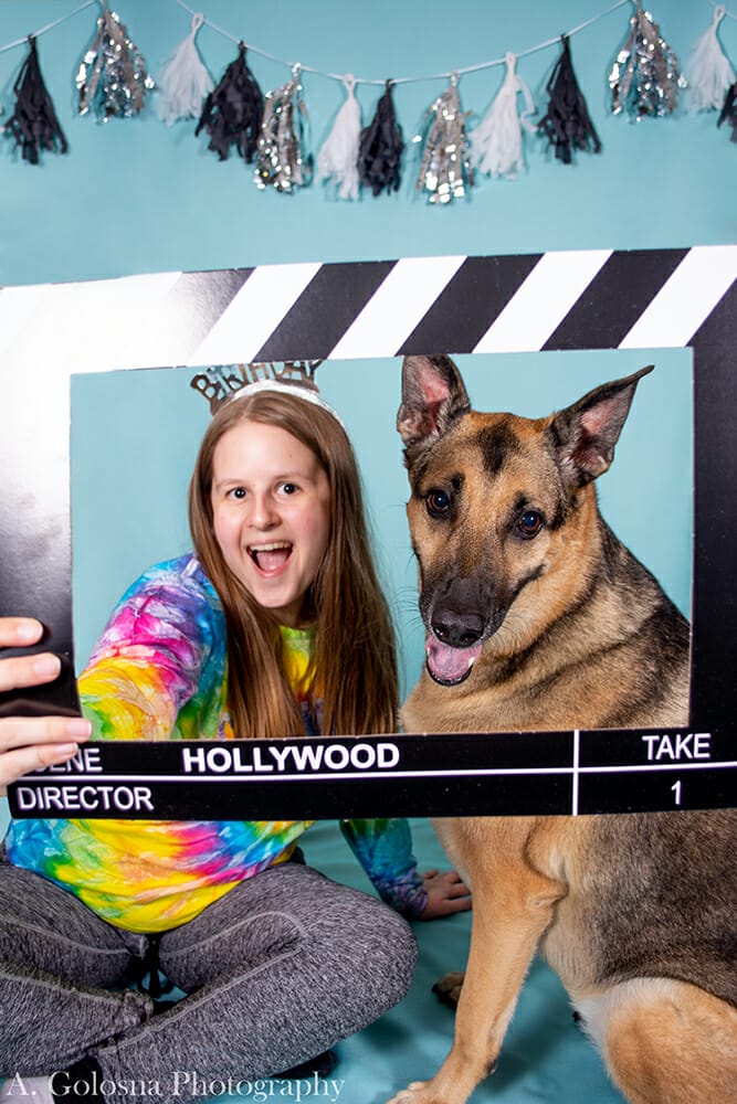 young woman wearing a tierra with her dog also wearing a tierra and getting a pet portrait