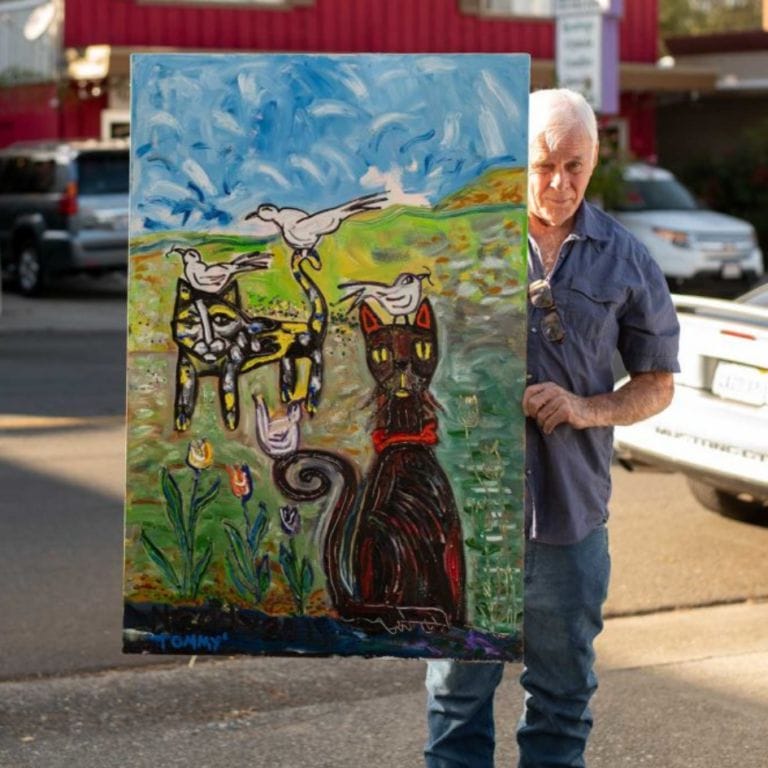 artist holding his painting