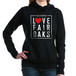 woman wearing a hoodie with love fair oaks on it