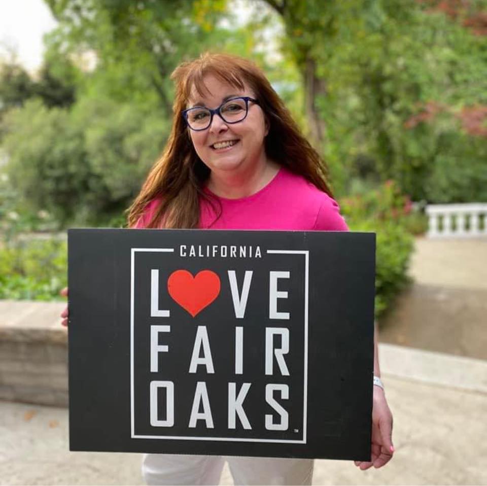 woman holding i love fair oaks sign