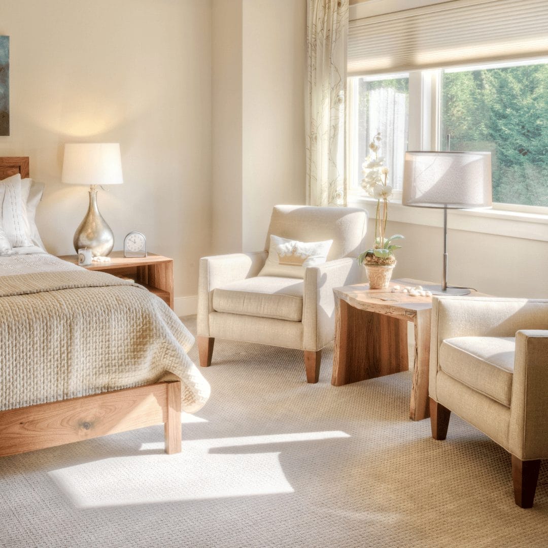 bedroom with two arm chairs by window